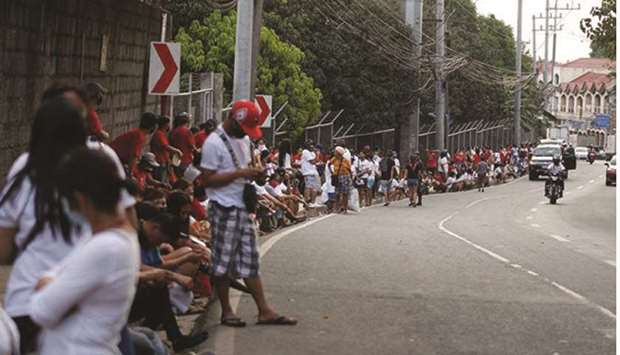 A massive line-up of residents including senior citizens and persons with disabilities (PWD) of Barangay Dalig in Antipolo city, wait to get the Social Amelioration Programme cash assistance.