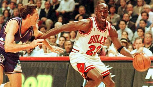 In this file photo taken on June 4, 1997, Chicago Bulls player Michael Jordan (right) in action against the Utah Jazz during a regular NBA game at the United Center in Chicago. (AFP)