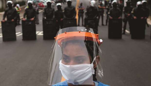 A resident of Paraisopolis, one of the cityu2019s largest slums, takes part in a protest in Sao Paulo, Brazil, to demand more aid from Sao Paulou2019s state government during the Covid-19 pandemic.