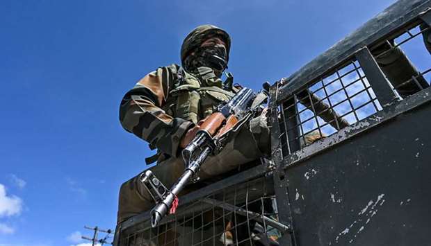 A soldier stands guards as gifts are being distributed to medical staff at a childrenu2019s hospital as a tribute to those involved in the fight against the spread of the Covid-19 in Srinagar yesterday.