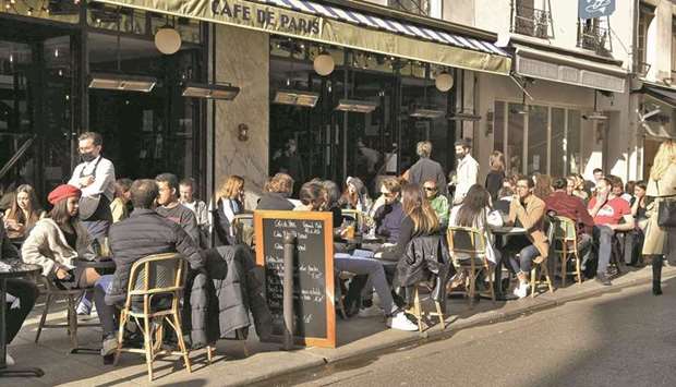 Customers sit on outside terraces, in Paris, yesterday. (AFP)