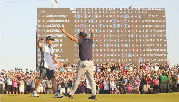 Phil Mickelson of the United States celebrates with brother and caddie Tim on the 18th green after winning the 2021 PGA Championship at the Ocean Course of Kiawah Island Golf Resort in Kiawah Island, South Carolina, United States, on Sunday. (AFP)