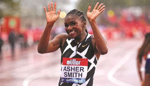 Britainu2019s Dina Asher-Smith celebrates after winning the womenu2019s 100m final during the Diamond League athletics meeting at Gateshead International Stadium in Gateshead, England. (AFP)