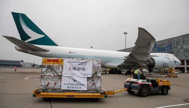 This file photo taken on February 27 shows a trolley carrying Pfizer-BioNTech Covid-19 coronavirus vaccines being transported to a warehouse after being unloaded from a Cathay Pacific cargo plane at Hong Kong International Airport in Hong Kong.