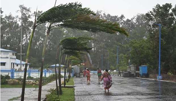 Locals residents walk to a shelter as Cyclone Yaas barrels towards India's eastern coast in the Bay of Bengal, in Digha some 190 Km from Kolkata.