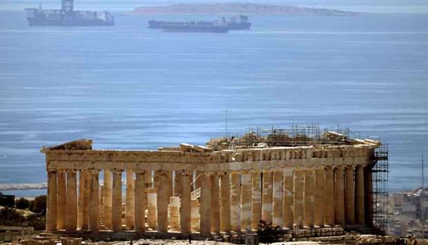 People visit the Parthenon temple atop the Acropolis hill archaeological site, amid the coronavirus disease (Covid-19) pandemic, in Athens, Greece