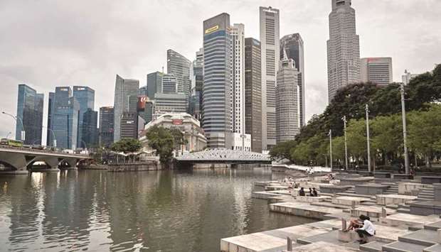 People sit at Esplanade park in the central business district of Singapore. Some of the worldu2019s largest tech corporations u2013 from Google to Microsoft Corp and Amazon u2013 are in talks with a new carbon offset trading platform in Singapore that would be among the first to be backed by a public stock exchange.