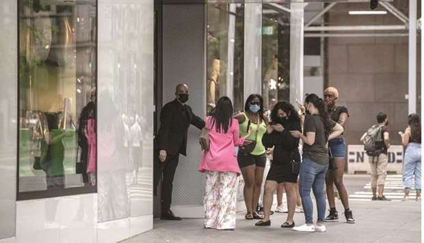 Shoppers wait to enter the Louis Vuitton store on Fifth Avenue in New York. The strong inflation readings reported by the Commerce Department yesterday had been widely anticipated as the Covid-19 pandemicu2019s grip eases, thanks to vaccinations, and will have no impact on monetary policy.