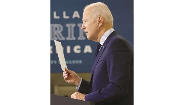 US President Joe Biden holds up a list of Republican lawmakers who he said have been u201cbragging aboutu201d his $1.9tn economic stimulus and Covid-19 relief bill called the u201cAmerican Rescue Planu201d to their constituents back in their districts after voting against it in Washington, as he delivers remarks on the economy at Cuyahoga Community College in Cleveland, Ohio, US.