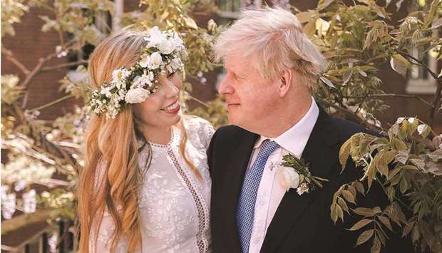 A handout picture released by 10 Downing Street yesterday shows British Prime Minister Boris Johnson and his wife Carrie Johnson in the garden of 10 Downing Street, London after their wedding on Saturday. (AFP)