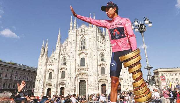 Team Ineos rider Colombiau2019s Egan Bernal celebrates with the raceu2019s Trofeo Senza Fine (Endless Trophy) on the podium after winning the Giro du2019Italia 2021 cycling race following the 21st and last stage in Milan yesterday. (AFP)