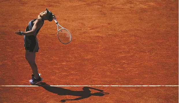 Japanu2019s Naomi Osaka serves the ball to Romaniau2019s Patricia Maria Tig (not pictured) during their French Open first round match at Roland Garros in Paris, France, yesterday. (AFP)