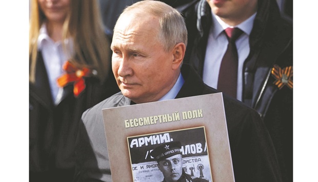 President Vladimir Putin takes part in the Immortal Regiment march on Victory Day, which marks the 77th anniversary of the victory over Nazi Germany in World War Two, in central Moscow yesterday.