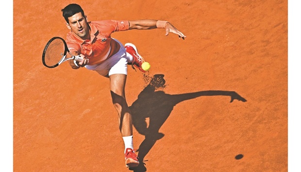 Serbiau2019s Novak Djokovic returns to Russiau2019s Aslan Karatsev during their first round match at the ATP Rome Open at Foro Italico in Rome yesterday. (AFP)