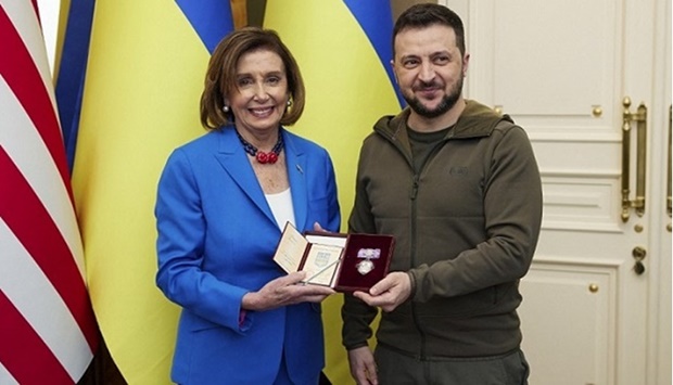 A handout photo released by the Ukrainian Presidential Press Service on May 1, 2022, shows President of Ukraine Volodymyr Zelensky (R) presents the Order of Princess Olga to US Speaker of the House of Representatives Nancy Pelosi. 