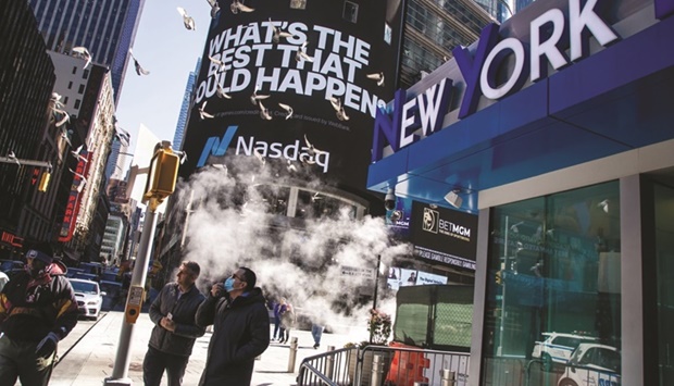 Pedestrians in front of the Nasdaq MarketSite in New York. Traders in the worldu2019s biggest bond market are bracing for another round of price swings driven by a Federal Reserve meeting, the Treasury Departmentu2019s quarterly debt-sales announcement and the continuing global economic uncertainty thatu2019s fuelling large moves in the foreign-exchange market.