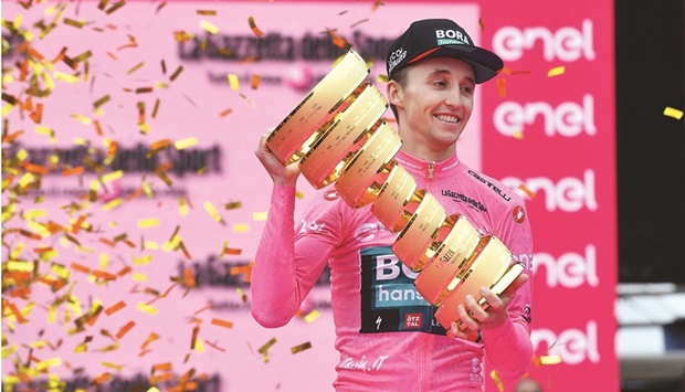 Bora-Hansgroheu2019s Jai Hindley celebrates with the trophy after winning Giro du2019Italia. (Reuters)