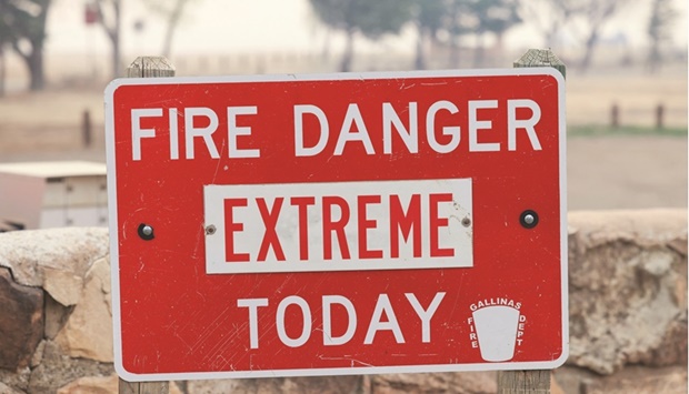 A sign indicating extreme fire danger is pictured outside Storrie Lake State Park as the Hermits Peak and Calf Canyon wildfires burn near Las Vegas, New Mexico.