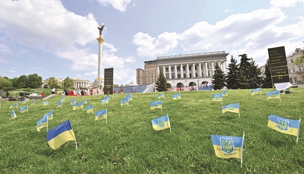 Ukrainian flags with names of people killed during the Russian invasion are seen at Kyivu2019s Independence Square.