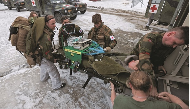 Swedish army medics take part in a field hospital evacuation simulation as part of military exercise called u201cCold Response 2022u201d, gathering around 30,000 troops from Nato member countries plus Finland and Sweden, amid Russiau2019s invasion of Ukraine, in Setermoen in the Artic Circle, Norway.