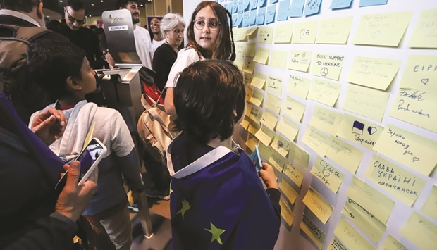 Visitors leave messages for Ukraine on the solidarity wall at the European Commission headquarters during the European Union (EU) Open Day yesterday.