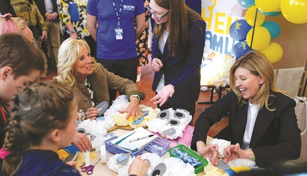 US First lady Jill Biden (left) and Ukraine President wife Olena Zelenska (right) with a group of children making tissue-paper bears for Motheru2019s Day gifts at School 6, a public school that has taken in displaced students in Uzhhorod, yesterday. (AFP)