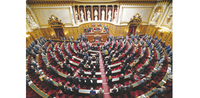 French Senate President Gerard Larcher and senators observe a minute of silence in remembrance of Socialist party senator Jean Germain at the Senate i