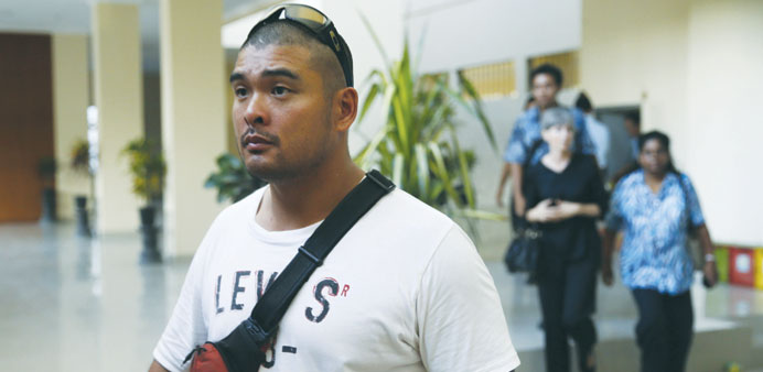 Michael Chan, brother of Australian death row prisoner Andrew Chan, walks after visiting the latter in the Kerobokan prison in Denpasar, on the Indone