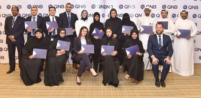 QNB employees who attended the programme pose for a photo.