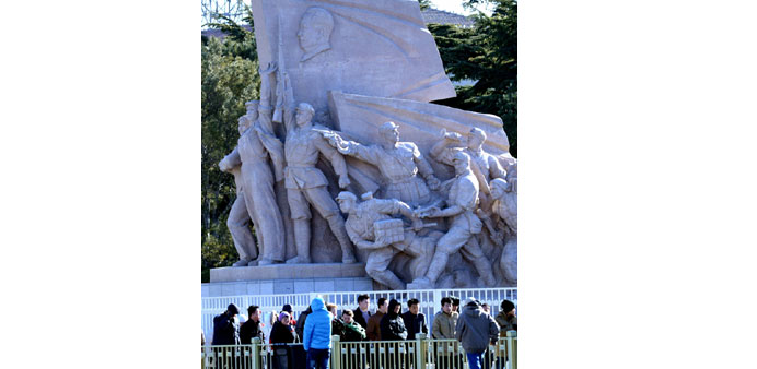 Visitors queue up outside the Mao Zedong mausoleum to wait their turns to see his preserved corpse, to mark the 120th anniversary of his birth in Beij