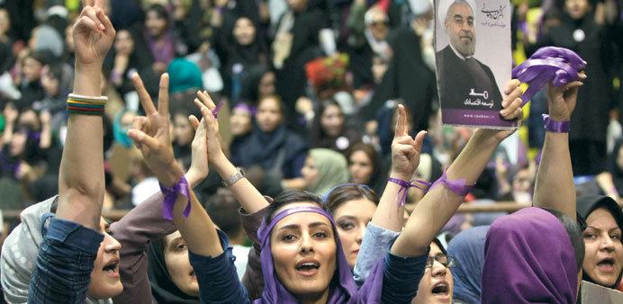  Female supporters hold posters of Rowhani during the rally in Tehran yesterday.