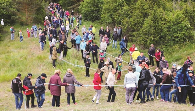 Locals take part in a tug-of-war between the Estonian islands of Hiiumaa and Saaremaa at the port of Soela (on Saaremaa island) on Saturday evening.