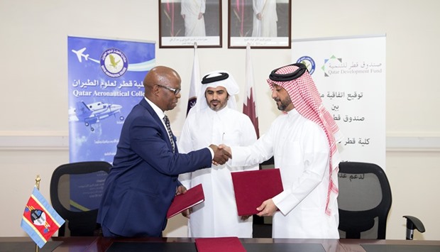 Director of QDFu2019s fund development projects Misfir Hamad al-Shahwani, director general of the Qatar Aeronautical College Sheikh Jabor bin Hamad al-Thani and Swaziland ambassador Felizwe P Dlamini at the agreement signing ceremony.