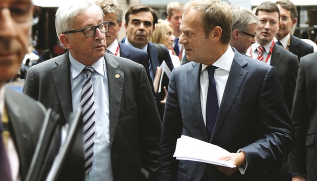 European Commission President Jean-Claude Juncker (left) and European Council President Donald Tusk arrive to address a joint news conference in Brussels yesterday.