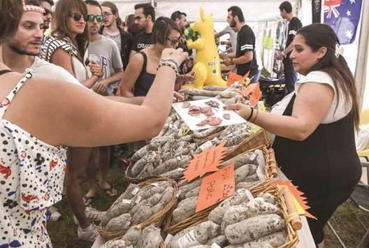 People taste dried sausage yesterday in Vanosc, southern France during the first sausage u2018World Cupu2019 (Mondial du saucisson).