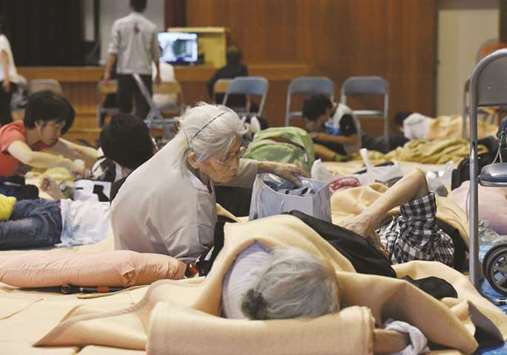 Earthquake evacuees rest in a shelter at an elementary school in Takatsuki city, Osaka prefecture yesterday.