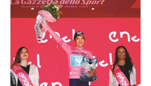 Team Movistar rider Ecuadoru2019s Richard Carapaz, wearing the overall leaderu2019s pink jersey, celebrates on the podium after stage twenty of the 102nd Giro du2019Italia yesterday. (AFP)