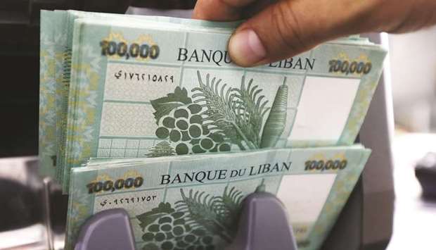 Lebanese pound banknotes are seen at a currency exchange shop in Beirut on Monday. As the crisis has worsened, nearly a quarter of 1mn people have lost their jobs, the labour federation says, the Lebanese currency has lost more than 60% of its value and savers have been locked out of their deposits.