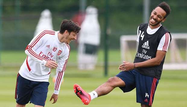 Arsenalu2019s Mezut Ozil and Pierre-Emerick Aubameyang share a laugh during a training session in London. (Arsenal)