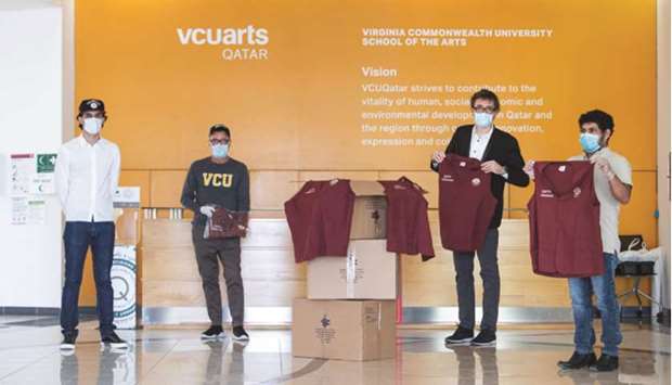 VCUarts Qatar officials with the volunteer uniform vests prepared for the MoPH.