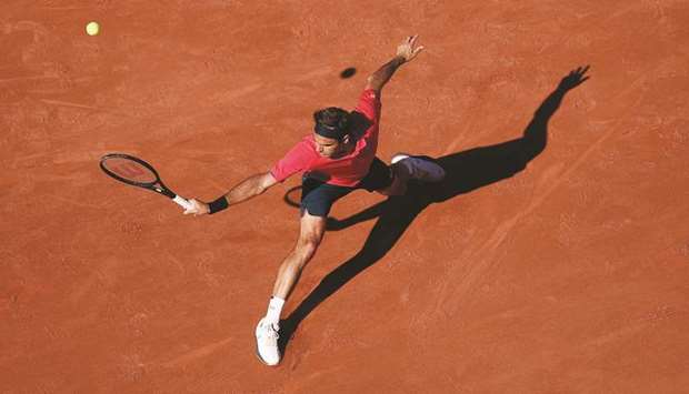 Switzerlandu2019s Roger Federer hits a return during his French Open first round match against Uzbekistanu2019s Denis Istomin (not pictured) at Roland Garros in Paris, France, yesterday. (Reuters)