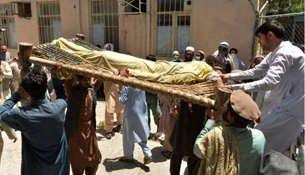 Relatives carry the body of a polio worker who was shot dead by gunmen in a string of targeted attacks on vaccinators in Afghanistan. AFP