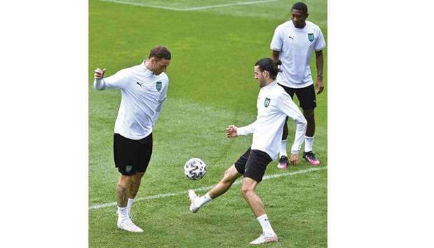 Austriau2019s David Alaba (right) looks on as Marko Arnautovic (left) and Florian Grillitsch train in Seefeld, Austria, yesterday. (AFP)