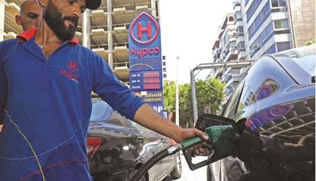 An employee fills a car with gasoline at a petrol station in Lebanonu2019s capital Beirut (file). Lebanonu2019s subsidy programme, which covers wheat, medicine and fuel, costs it around $6bn a year, half of which goes to fuel.