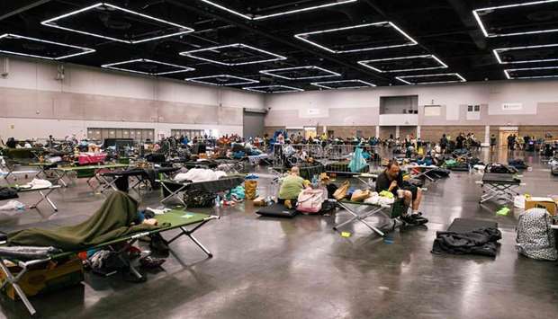 People rest at the Oregon Convention Center cooling station in Oregon, Portland as a heatwave moves over much of the United States.