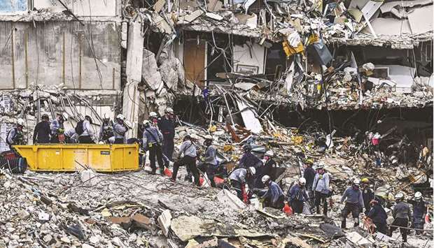 Search and rescue teams look for possible survivors in the partially collapsed 12-story Champlain Towers South condo building in Surfside, Florida, yesterday.