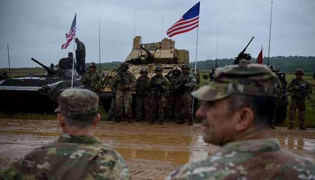 US army soldiers stand in formation during a military tactical training exercise