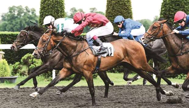 Oisin Murphy (second from left) rides Sunstrike to victory in the Maiden Fillies' Stakes in Kempton, England, on Wednesday. (John Hoy)