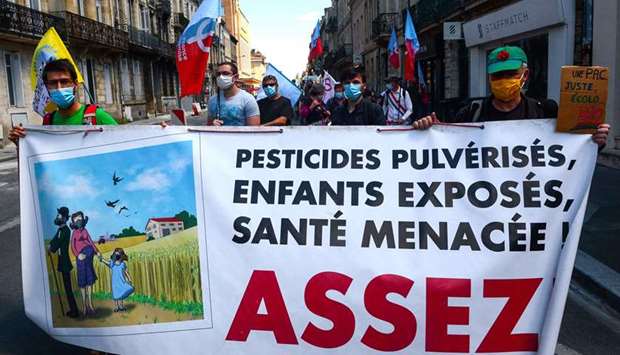 Protesters hold a banner reading 'sprayed pesticides, exposed children, endangered health, enough' during a rally called by 'Bio Nouvelle-Aquitaine', against the Plan Strategique National (PSN) bill for the next Common Agricultural Policy (2023-2027), in Bordeaux