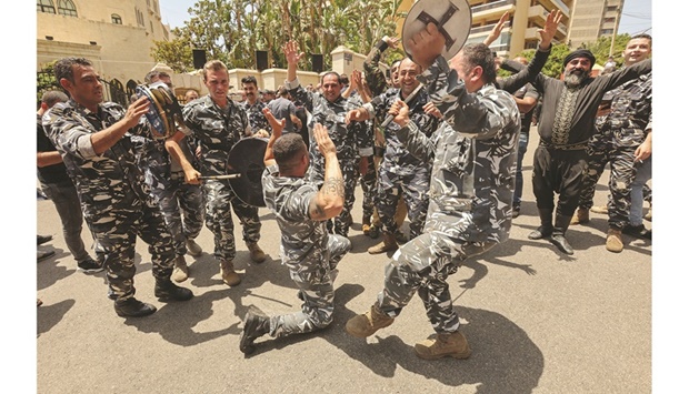 Members of Lebanese police dance as they celebrate Nabih Berriu2019s re-election as parliament speaker in Beirut, yesterday.